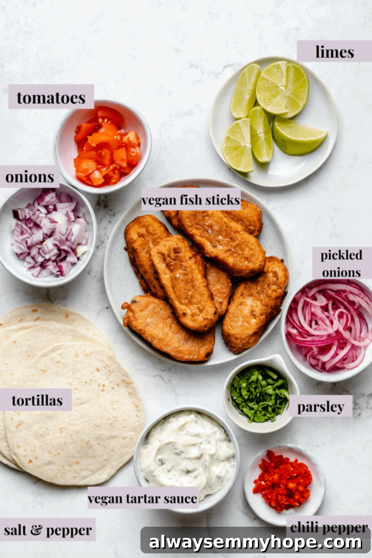 Golden Beer Battered Vegan Fish Tacos 3 Overhead view of all ingredients laid out for making vegan fish tacos, including hearts of palm, tortillas, pico de gallo, and sauces.