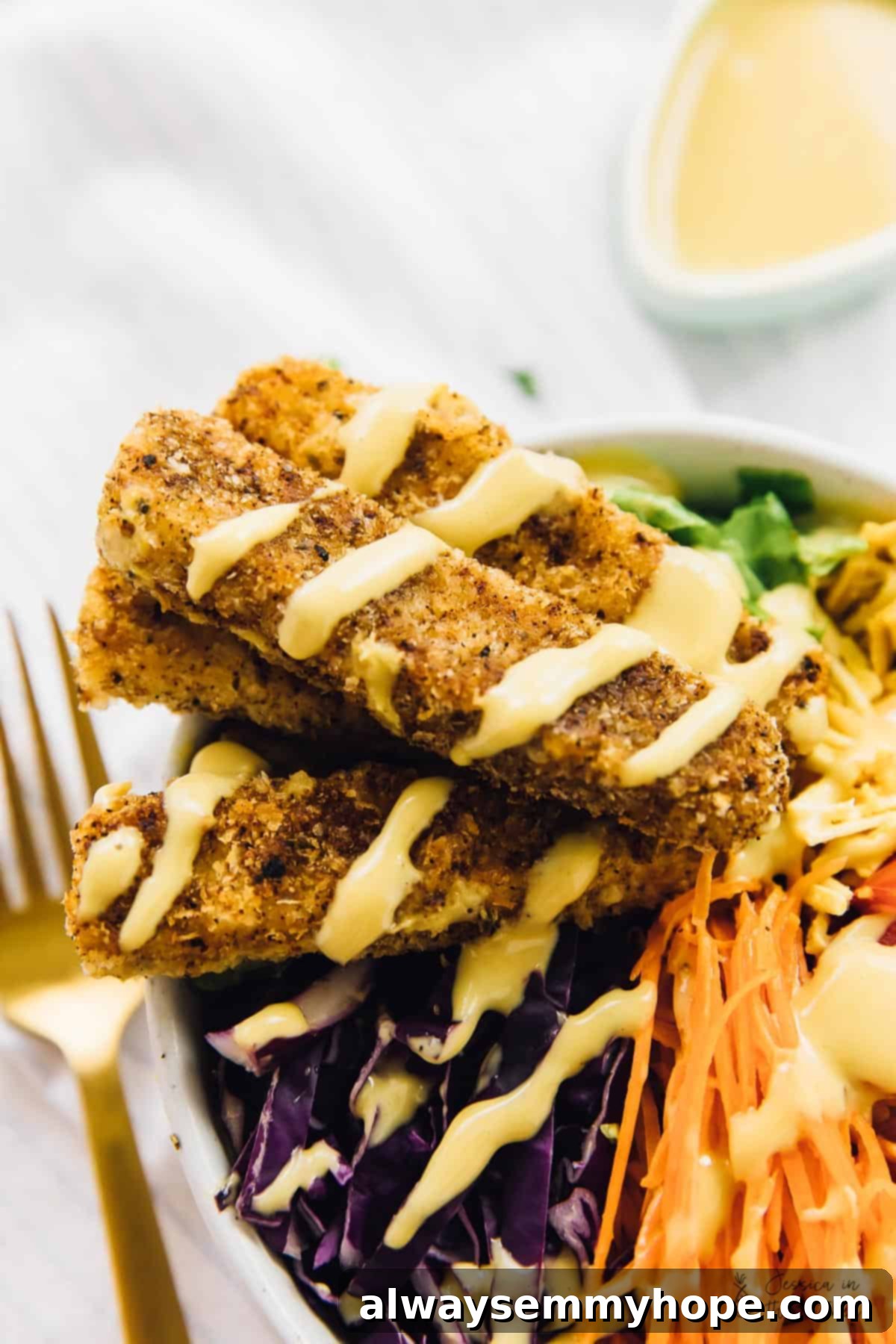 Vegan Cajun fried tofu salad generously drizzled with a rich maple mustard dressing.