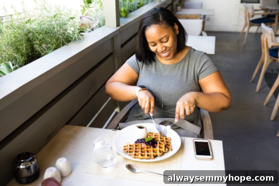 5 Weeks, 5 Lessons: A California Reflection 4 Jessica enjoying a plate of waffles with fresh fruit in a bright, inviting restaurant.