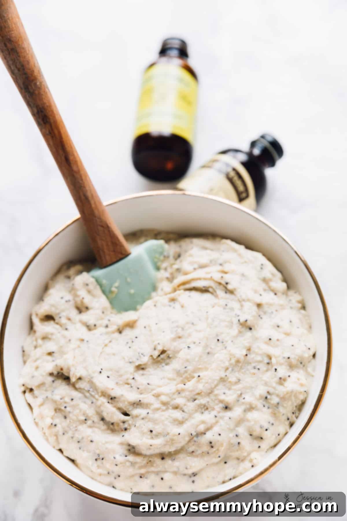 Close-up of waffle batter being mixed in a large bowl with a whisk.