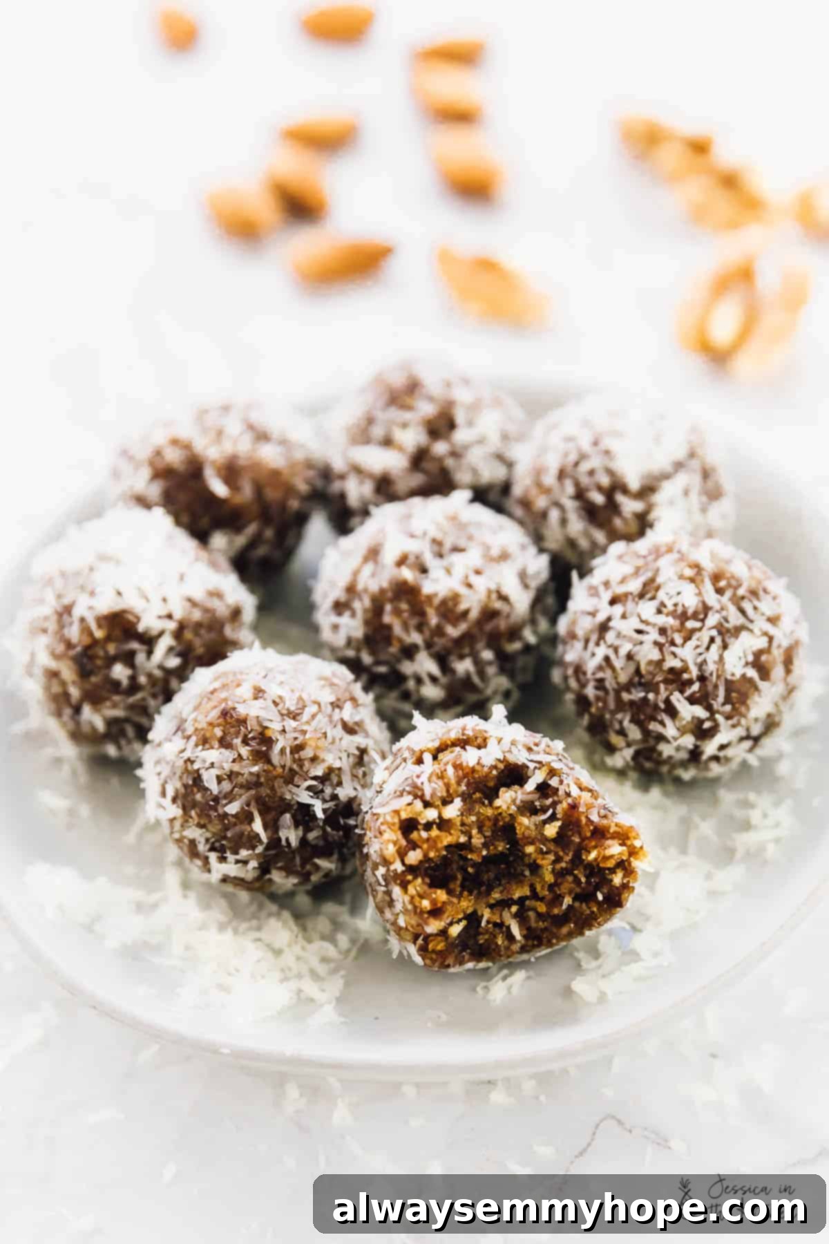 Quick and Zesty Vegan Coconut Lemon Energy Bites 4 Close-up of coconut lemon energy bites on a transparent glass plate, highlighting the rough coconut coating and golden interior.