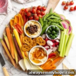 Master the Art of the Perfect Crudité Platter 3 Overhead view of vegetable crudité platter with bowls of hummus and olives