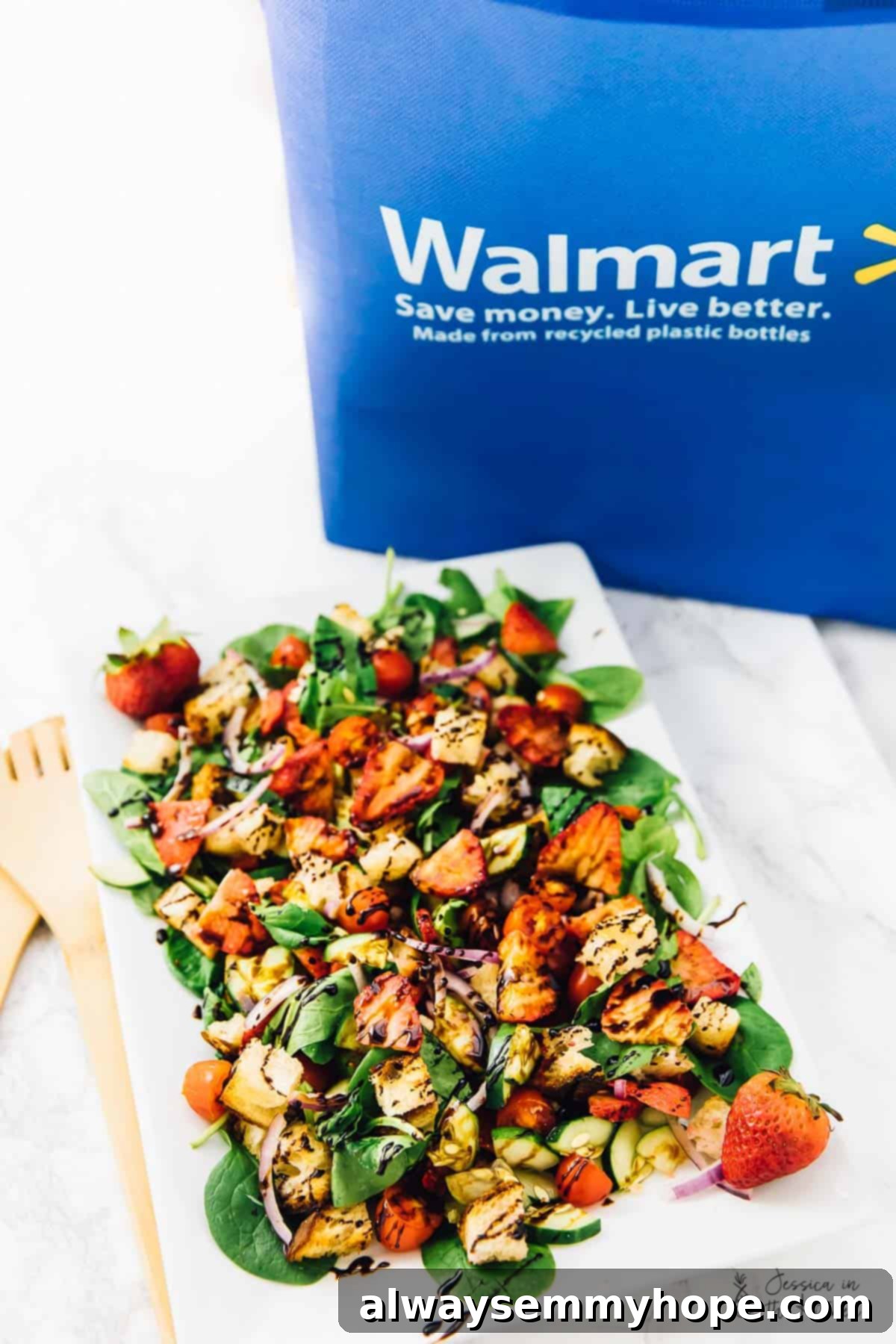 Strawberry Panzanella Salad artfully arranged, with a subtle hint of a Walmart shopping bag in the background, symbolizing fresh, accessible ingredients.