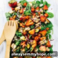 Strawberry panzanella salad in a long white dish.