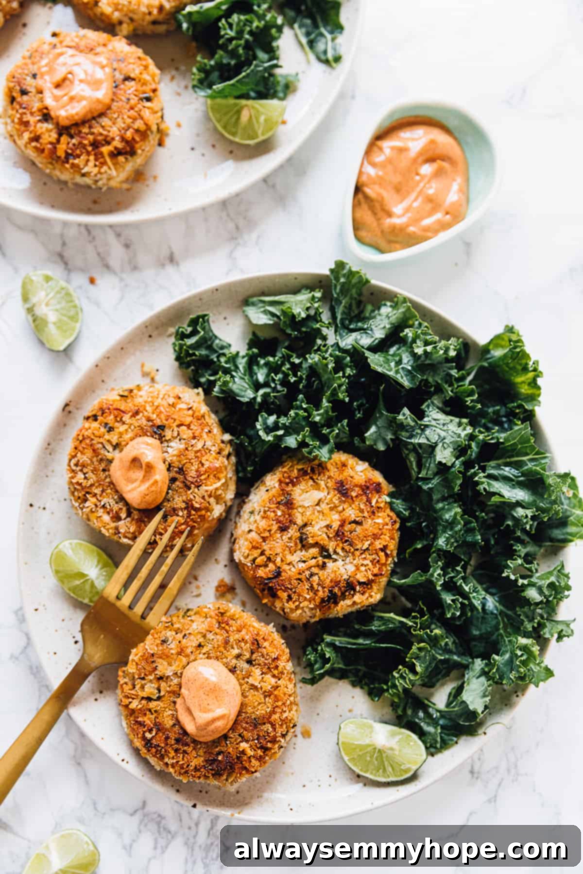 Top down view of vegan crab cakes on a plate with salad on the side.