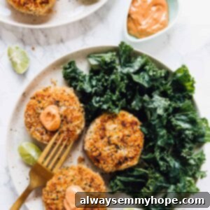 Top down view of vegan crab cakes on a plate with salad on the side.