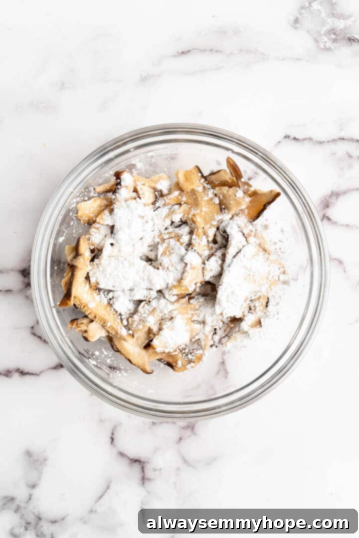 Overhead view of shiitakes in glass bowl with cornstarch