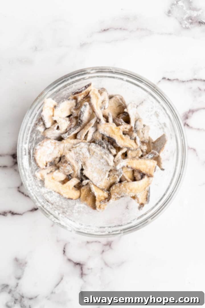 Overhead view of cornstach-coated shiitakes in bowl
