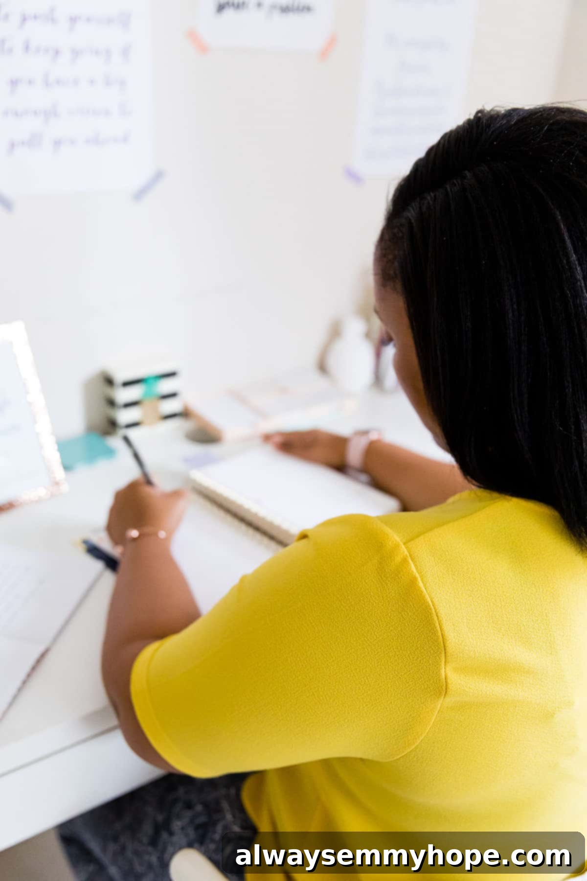 Behind the Plates: A Day with Full-Time Food Blogger Jessica 9 Over the shoulder shot of jessica writing at a desk.