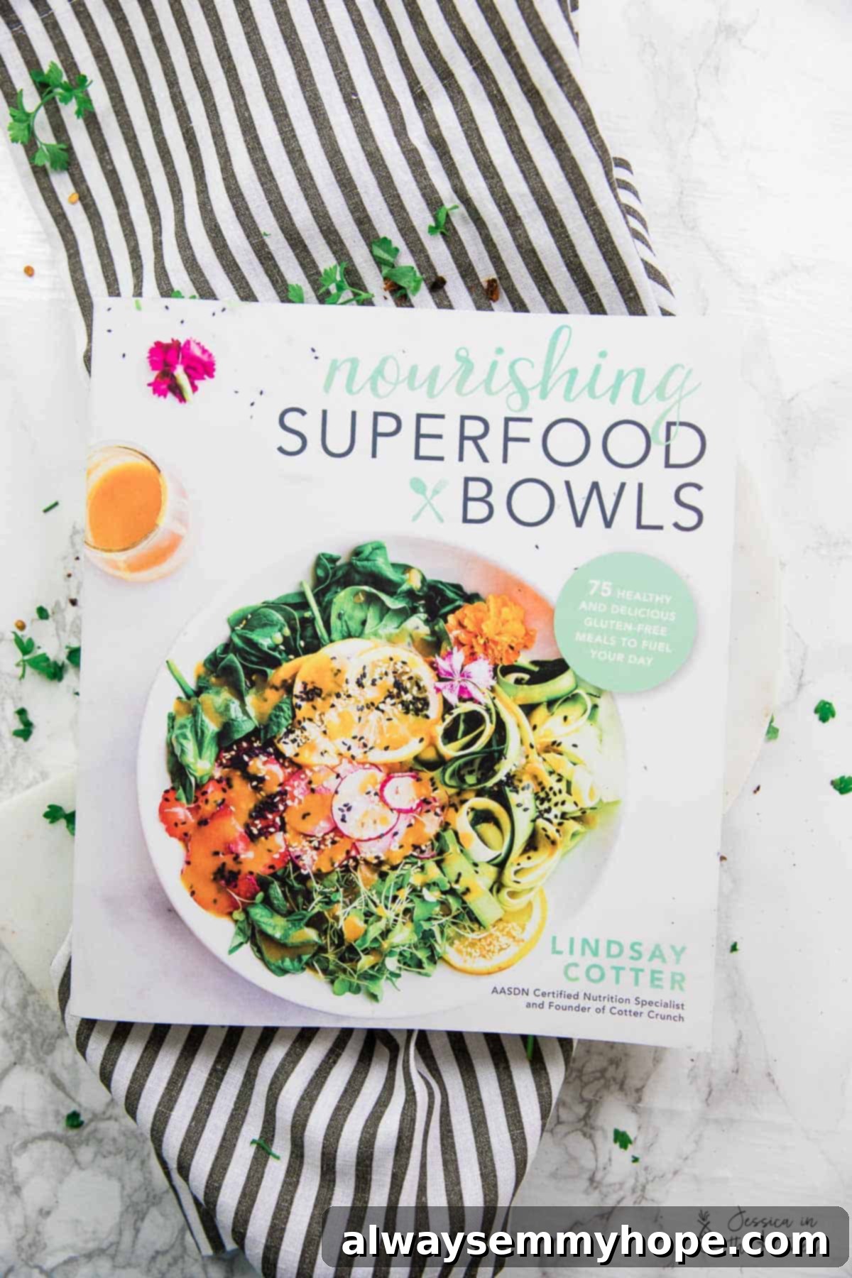 Curried Satay Veggie Power Bowls 3 Close-up of Lindsay Cotter's 'Nourishing Superfood Bowls' cookbook, featuring a healthy bowl recipe.