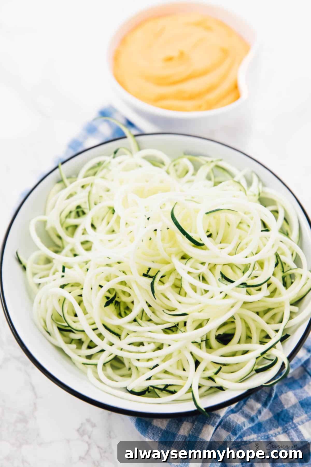 Curried Satay Veggie Power Bowls 4 Close-up of perfectly spiralized zucchini noodles in a bowl, ready for sauce.
