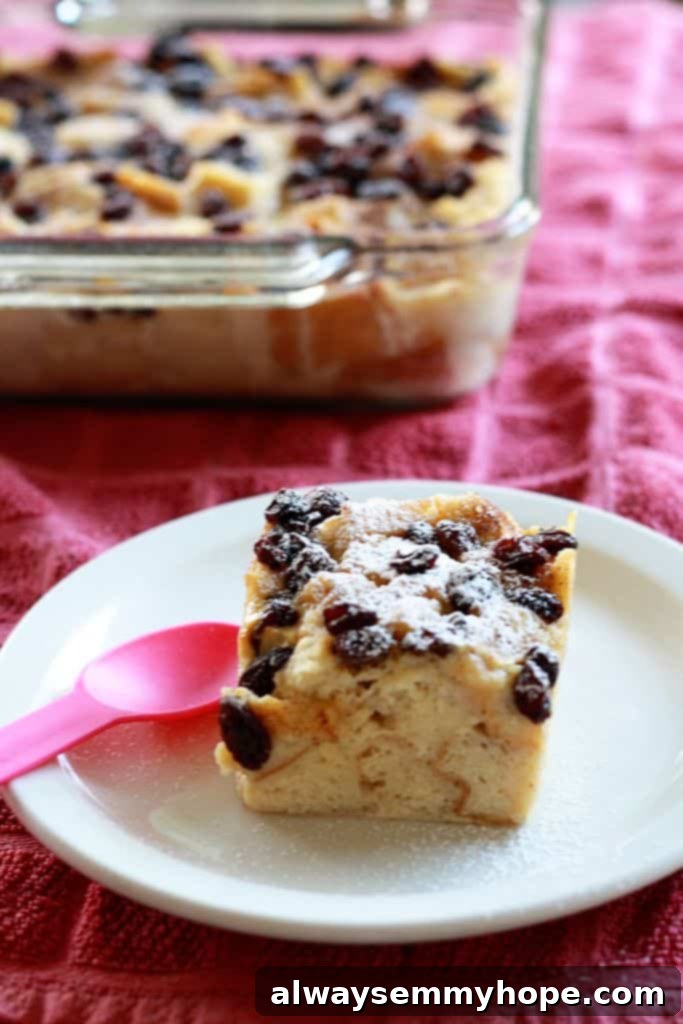 A very traditional bread pudding with raisins, for my brother's birthday! With powdered sugar and rum, this one's sure to please. A square of traditional bread pudding.