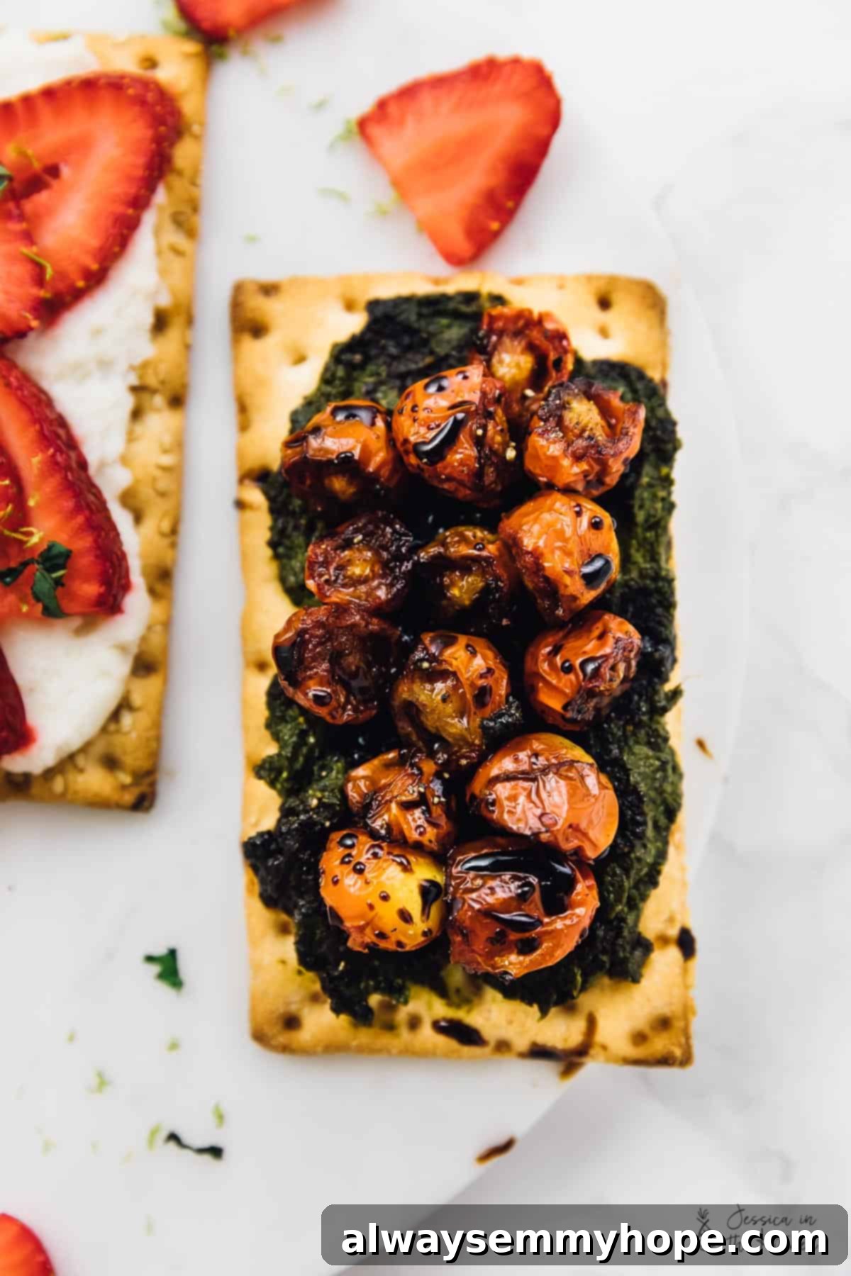 3 Quick and Easy Summer Appetizers With Video 6 Close-up overhead view of a crispbread topped with vibrant green pesto and perfectly burst red cherry tomatoes, drizzled with balsamic glaze.