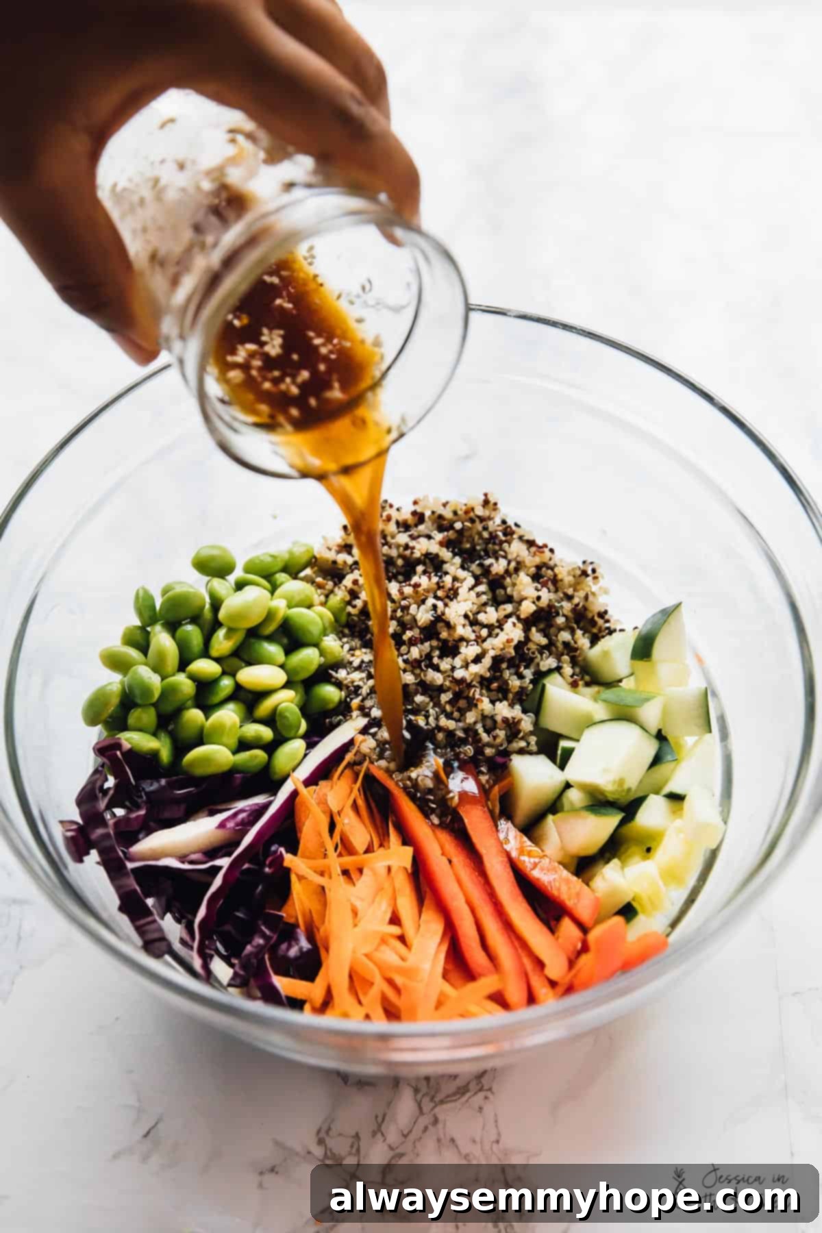 Speedy Sesame Ginger Quinoa Salad 6 Pouring dressing into bowl of quinoa salad ingredients, showing the mixing process
