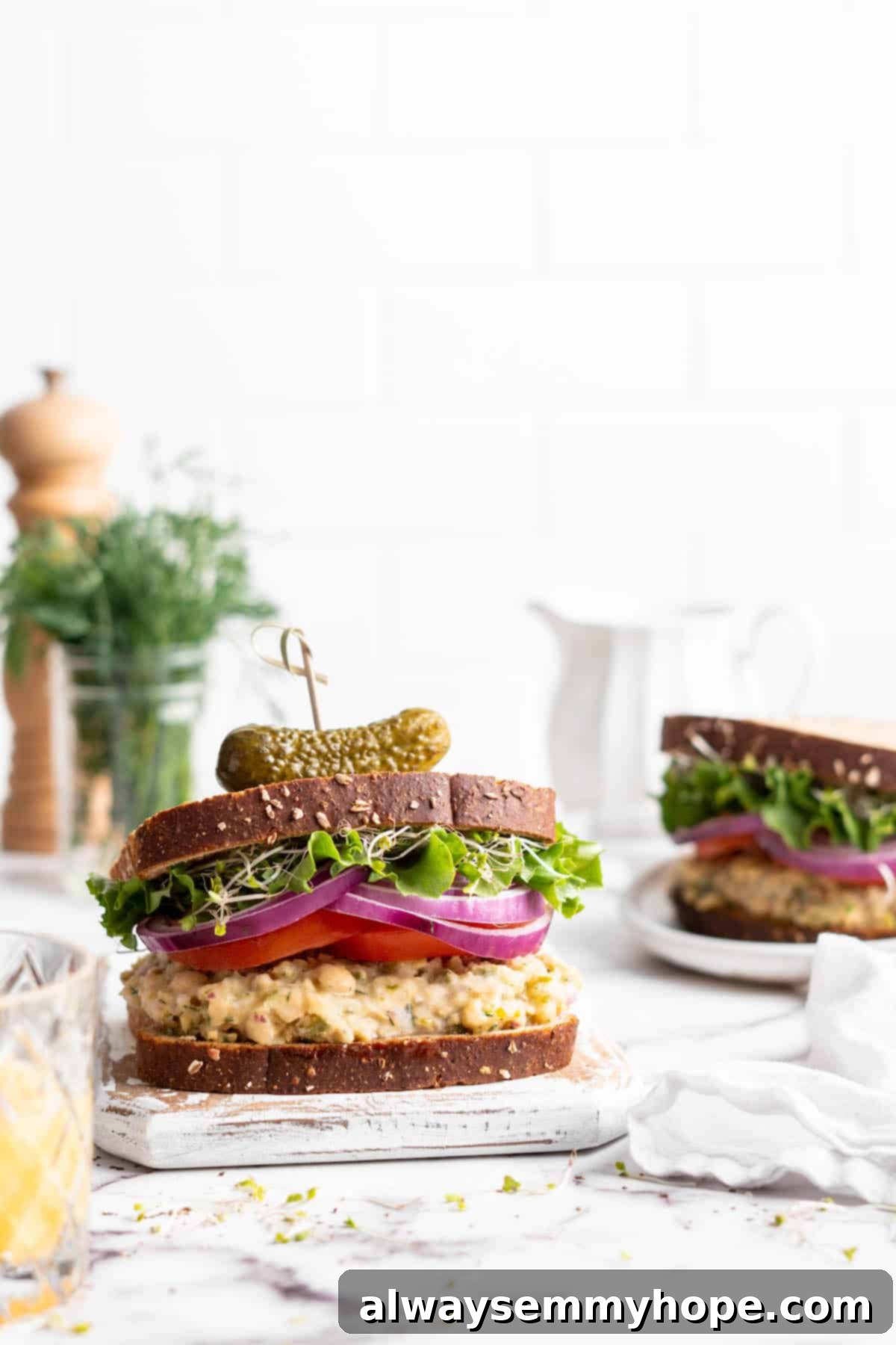 Creamy Vegan Chickpea Tuna Salad 6 Vegan tuna sandwiches topped with tomatoes, red onions, and sprouts