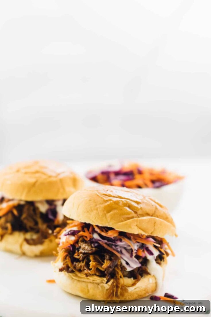 10 Irresistible Vegan BBQ Recipes for Grilling Season 11 Hearty Vegan Pulled "Pork" Mushroom Sandwiches, featuring shredded oyster mushrooms coated in BBQ sauce, served on toasted buns.