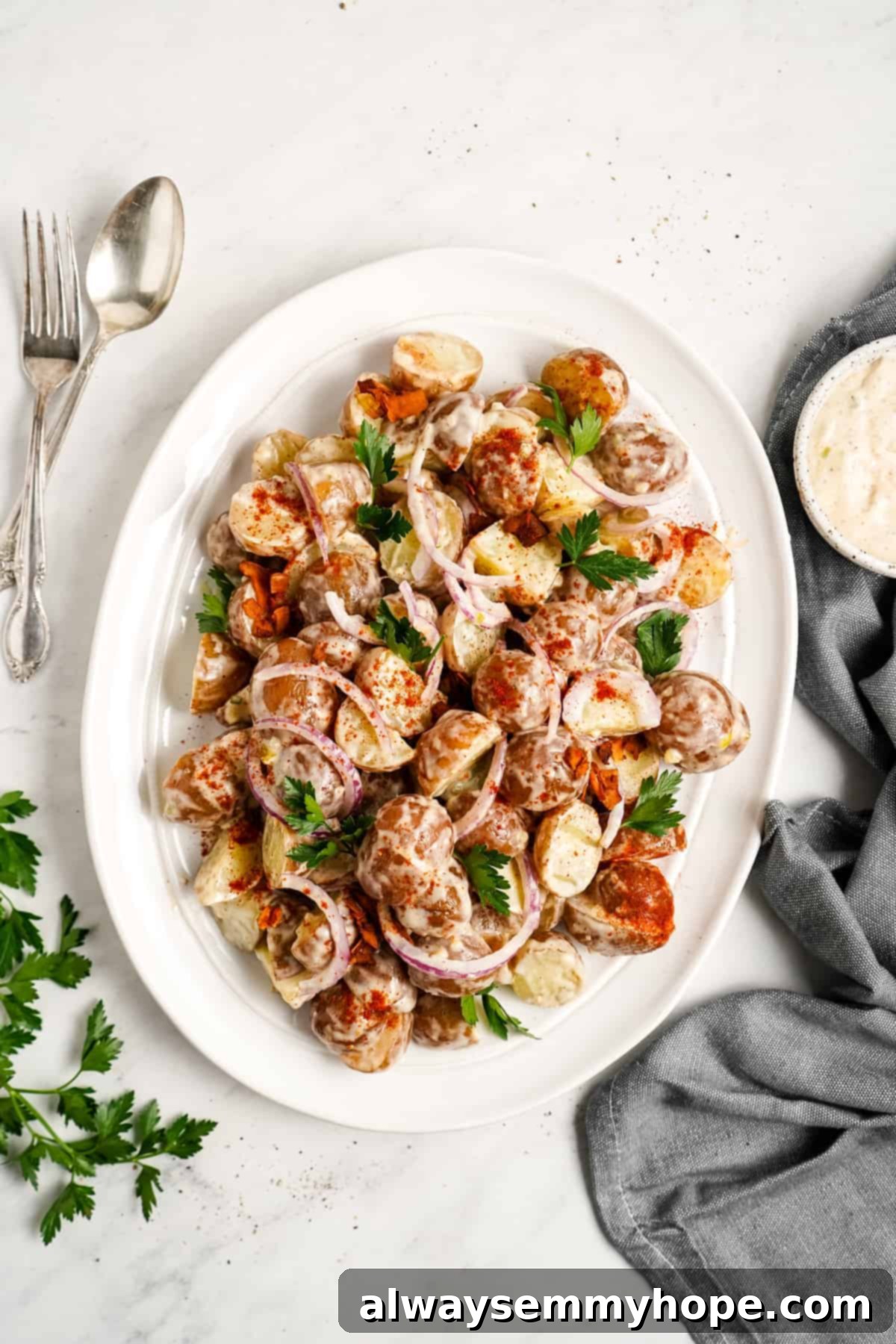 A serving dish filled with creamy vegan potato salad, ready to be enjoyed.