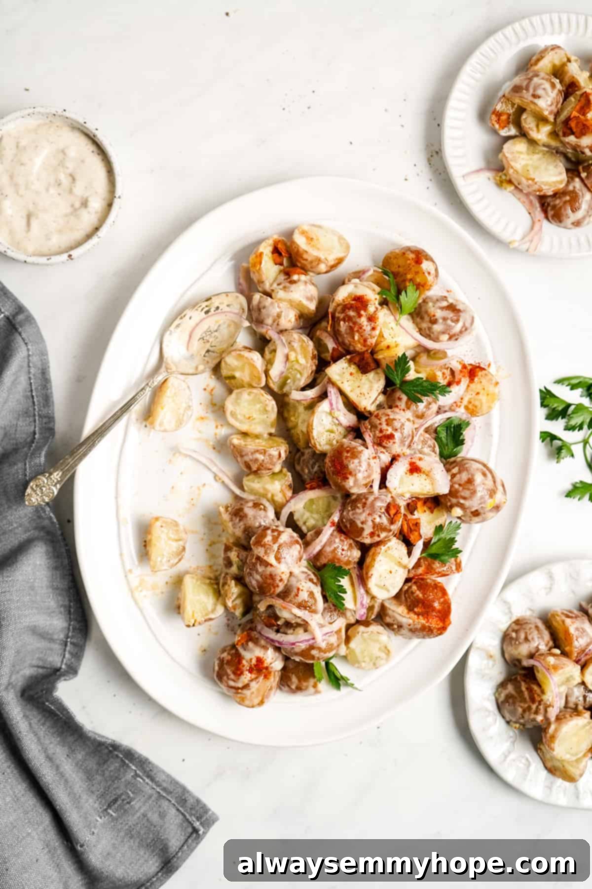 Close-up of vegan potato salad featuring red onion and crispy coconut bacon.