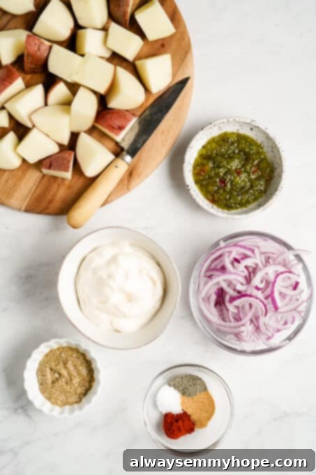Assorted ingredients for vegan potato salad laid out on a surface.