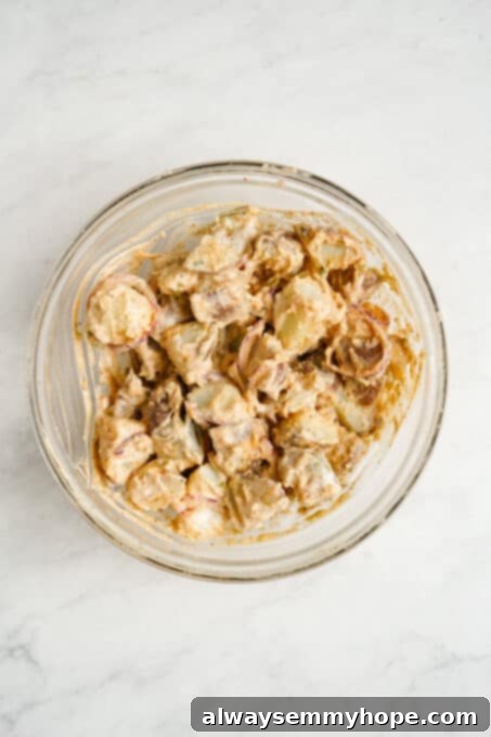 Finished vegan potato salad mixed in a bowl, showing creamy texture.