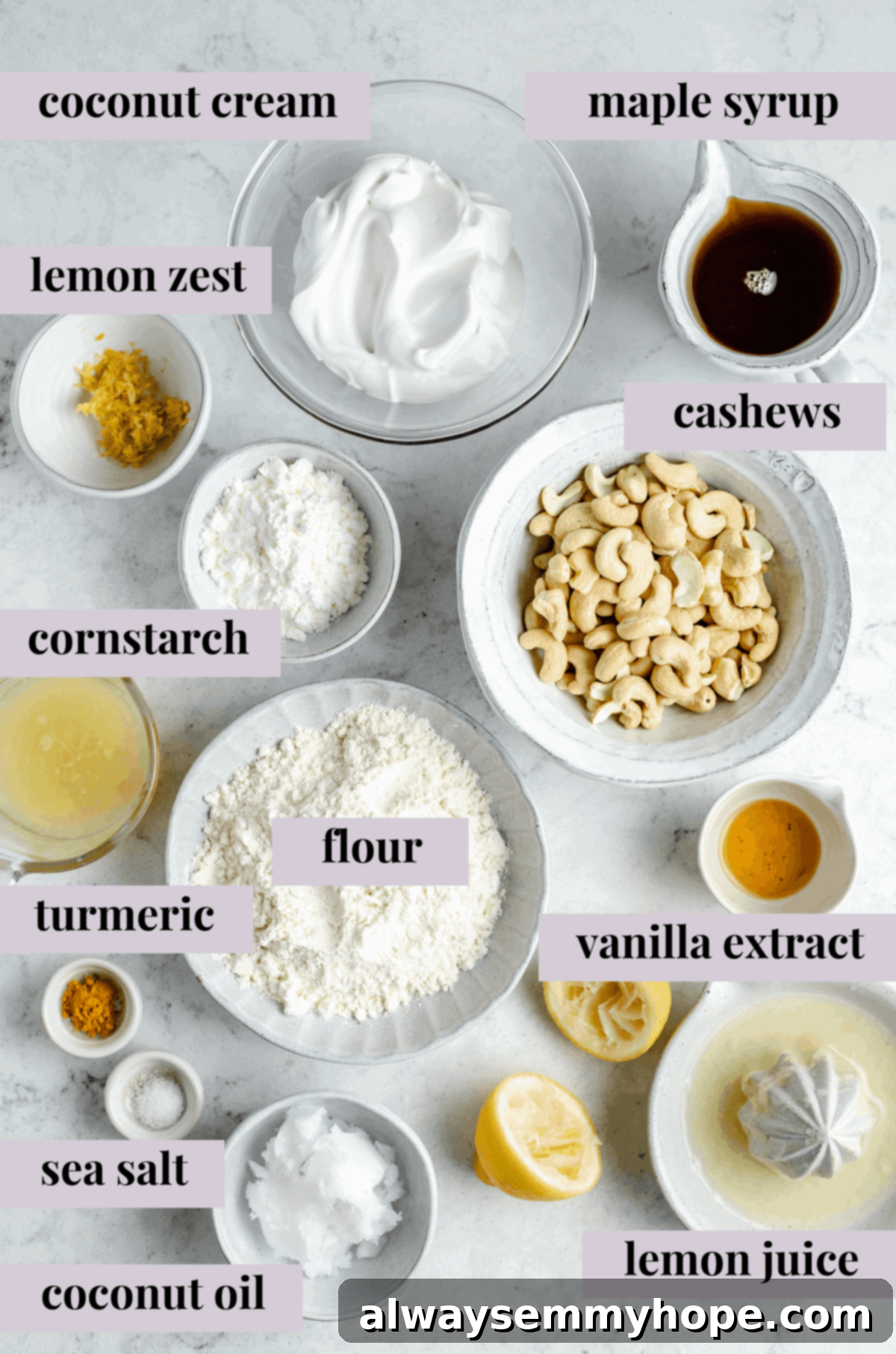 Various ingredients for vegan lemon bars laid out on a table, including lemons, cashews, flour, and maple syrup.