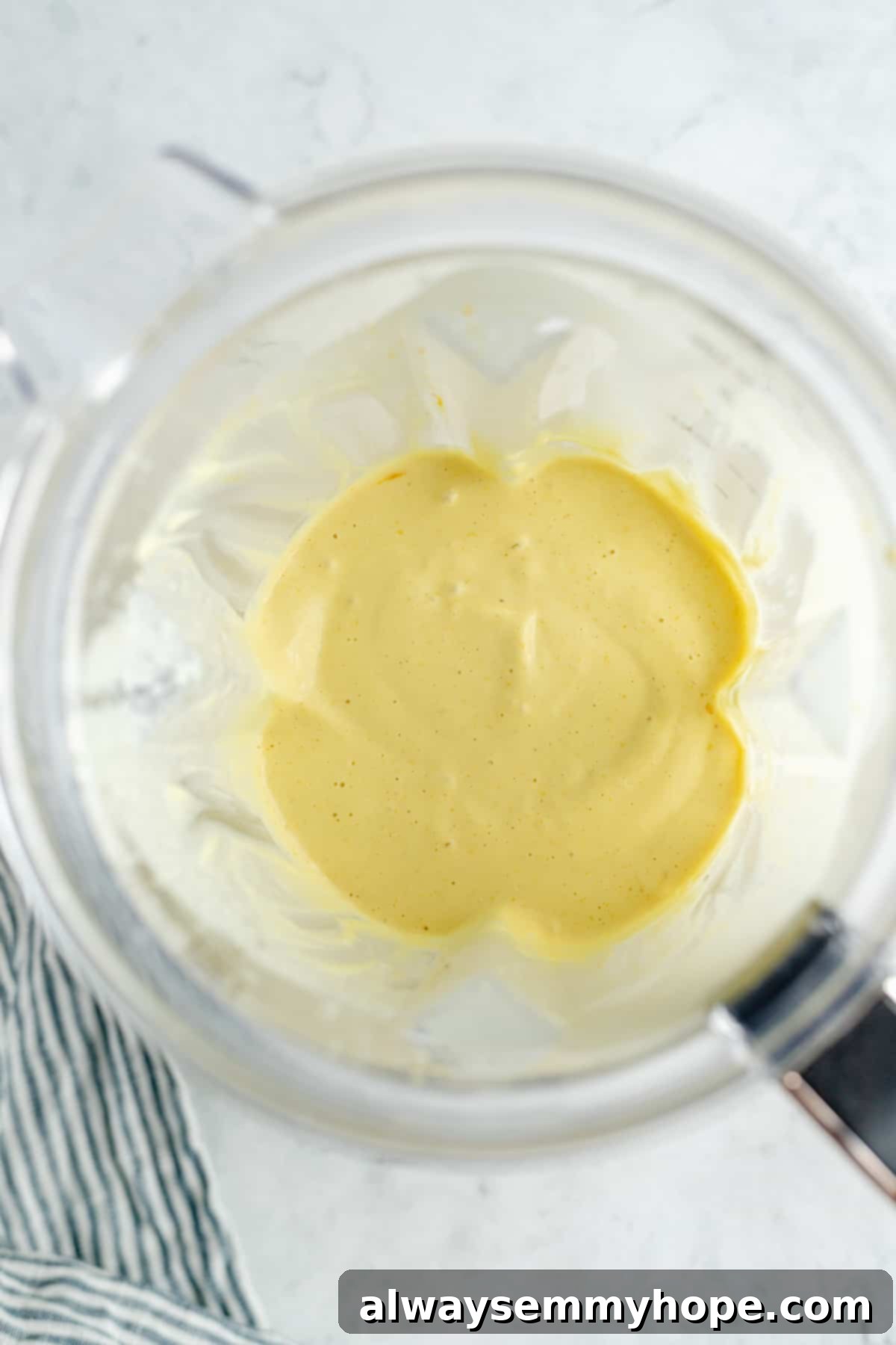 Blended vegan lemon filling in a high-powered blender, showing a smooth, creamy texture.