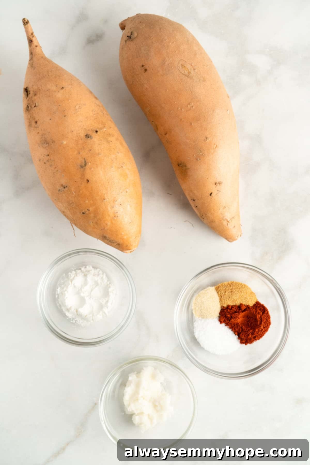Overhead view of all the raw ingredients for sweet potato tater tots laid out on a white surface