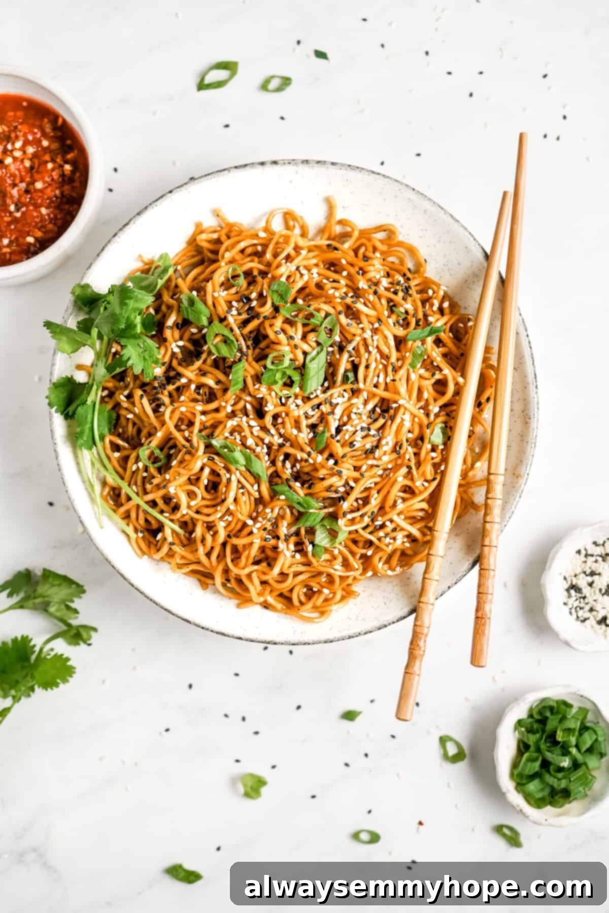 A close-up shot of Chinese noodles with chopsticks, showcasing the perfect coating of sesame sauce.