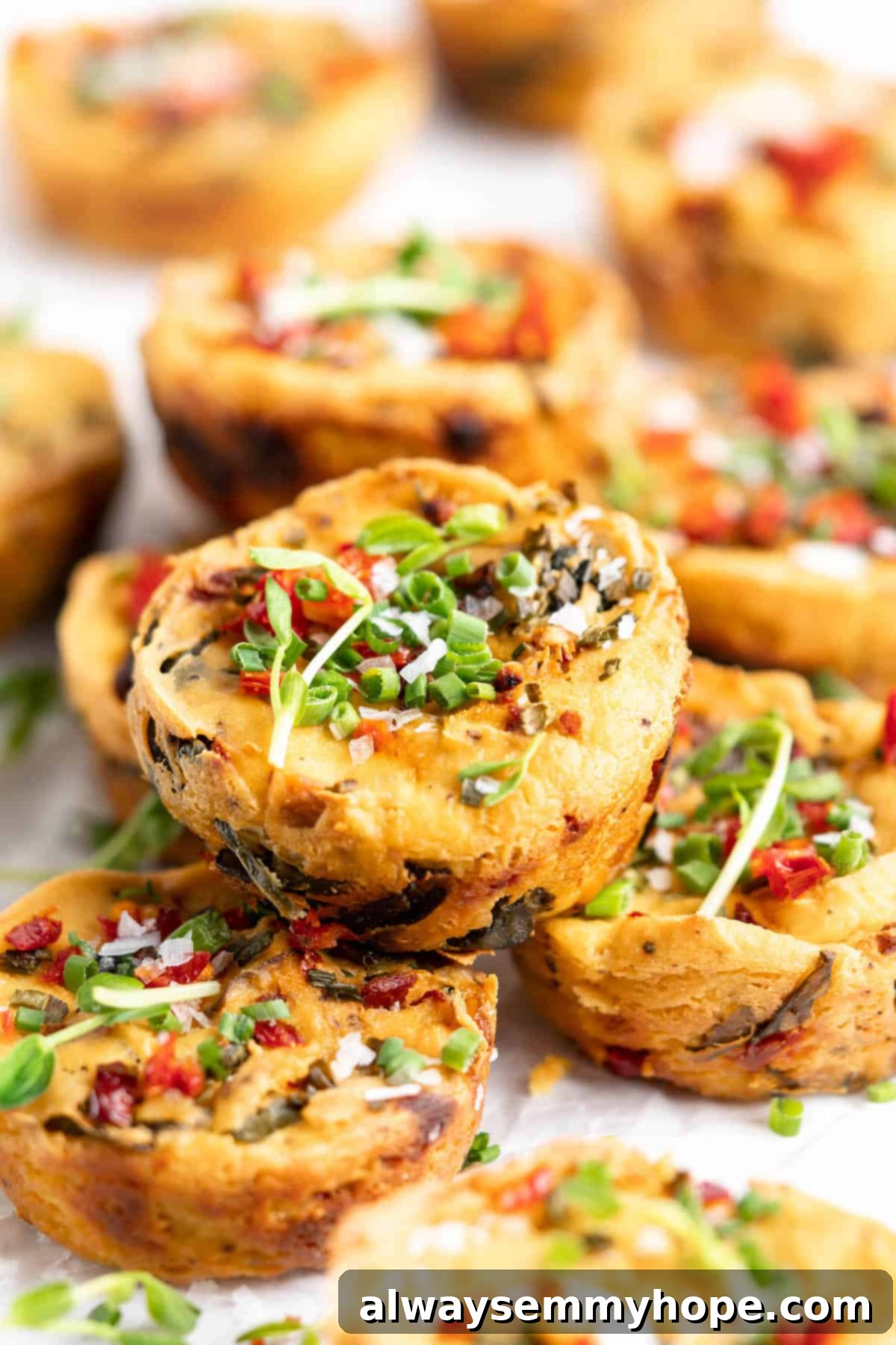 Delicious stack of freshly baked vegan quiche muffins with a golden top, ready for breakfast or brunch.