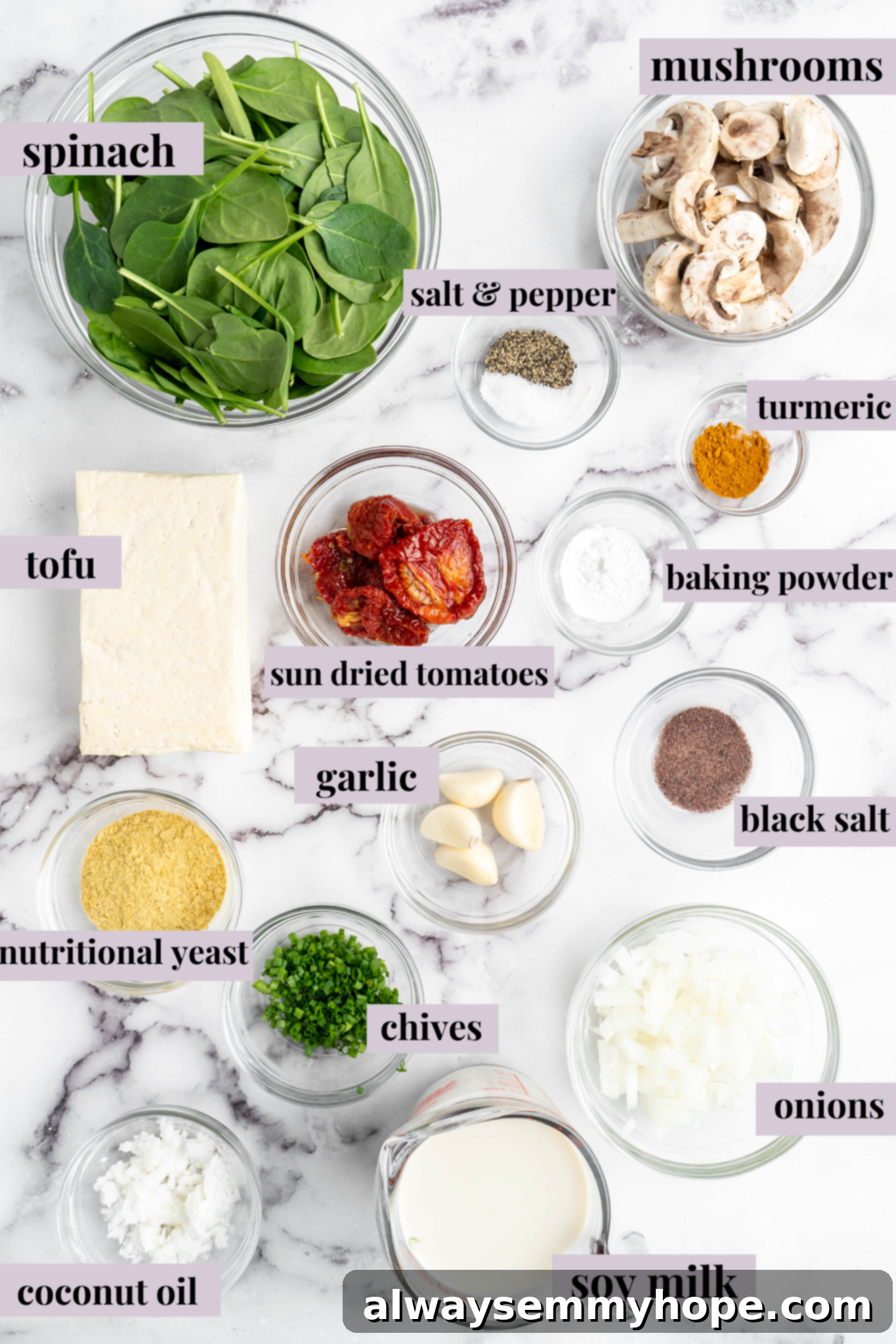 Fresh ingredients laid out for preparing vegan quiche muffins, including tofu, mushrooms, and spinach.