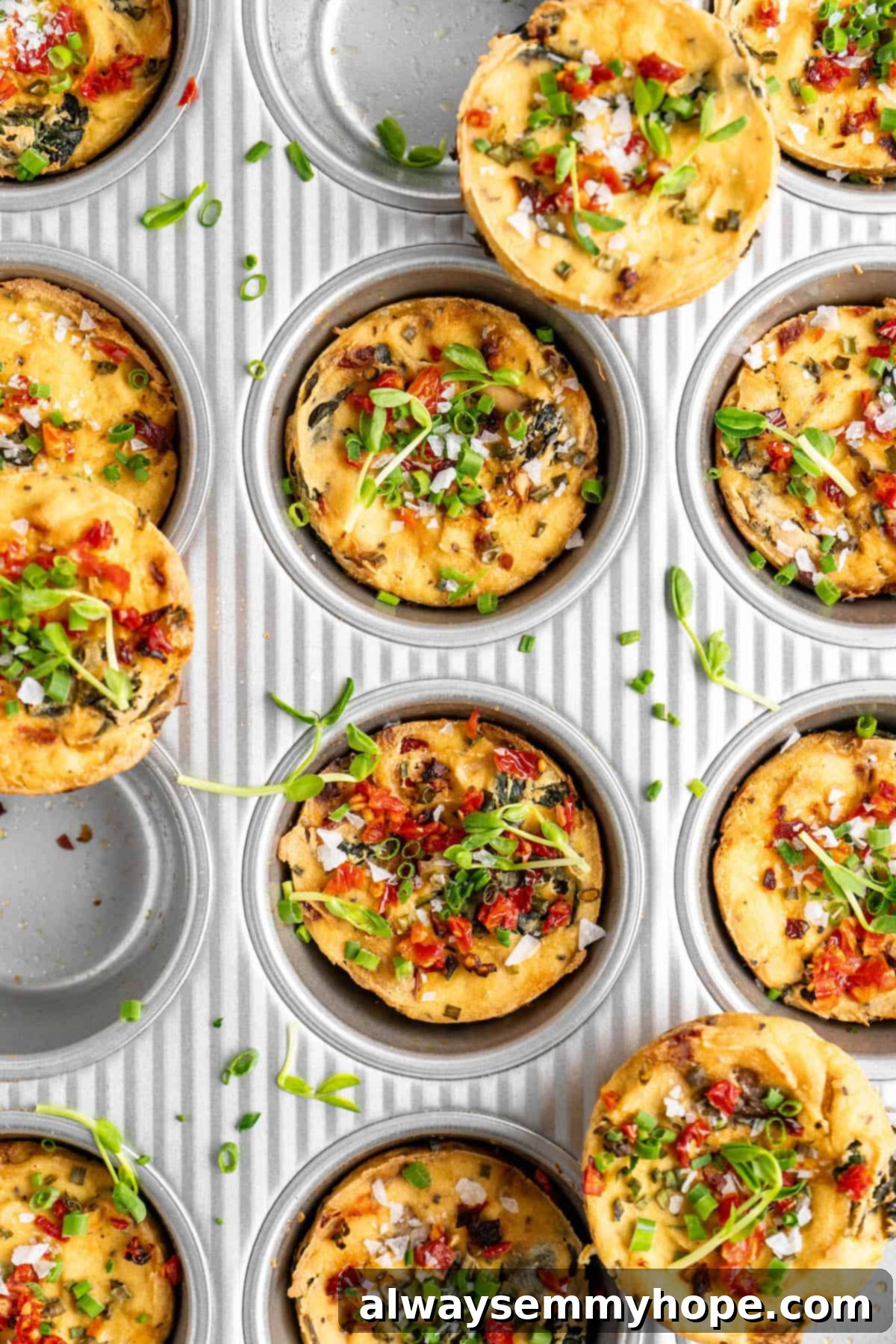Freshly baked vegan quiche muffins in a muffin tin, golden and perfectly set.