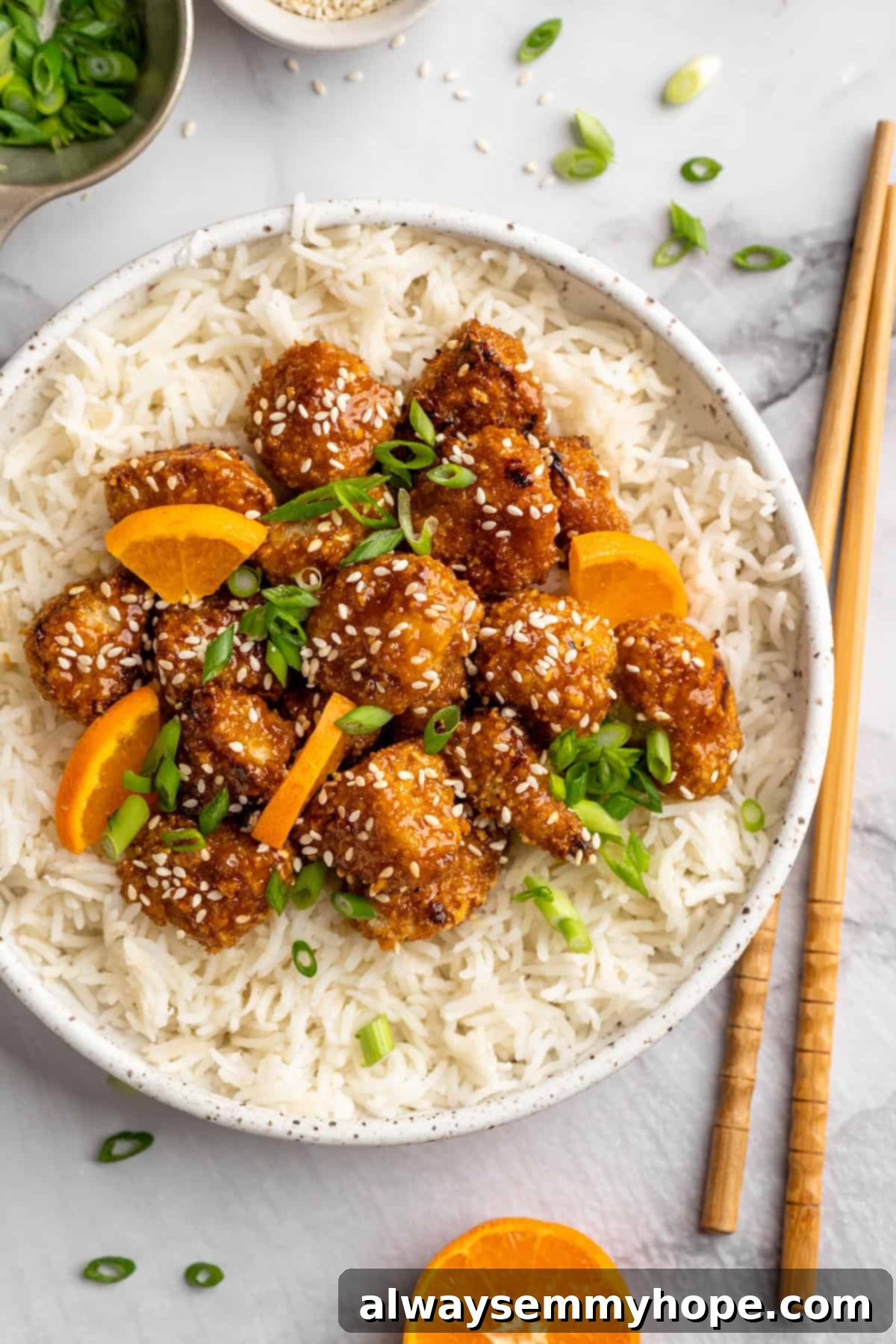 Orange Cauliflower Served with Fluffy Rice Overhead view of orange cauliflower in bowl with rice