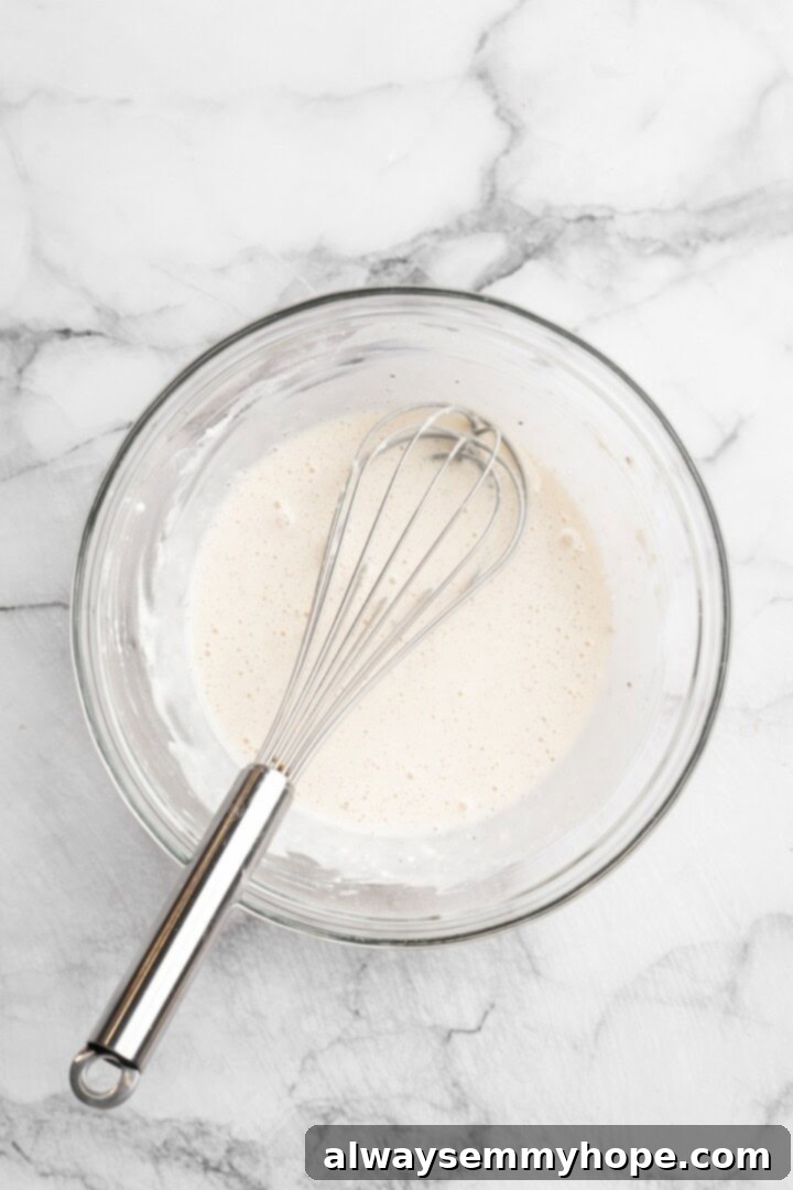 Preparing the Cauliflower Batter Overhead view of batter in bowl with whisk