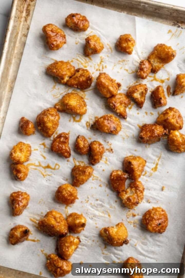 Final Bake: Orange Glazed Cauliflower Overhead view of orange cauliflower on parchment-lined sheet pan