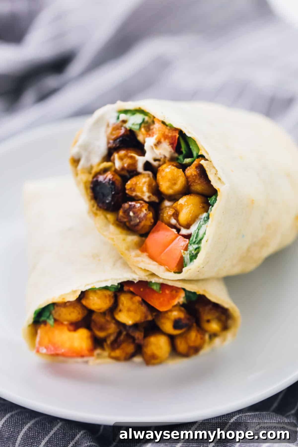 Smoky BBQ Chickpea Wraps with Creamy Ranch 4 Two halves of a bbq chickpea wrap stacked on top of one another.