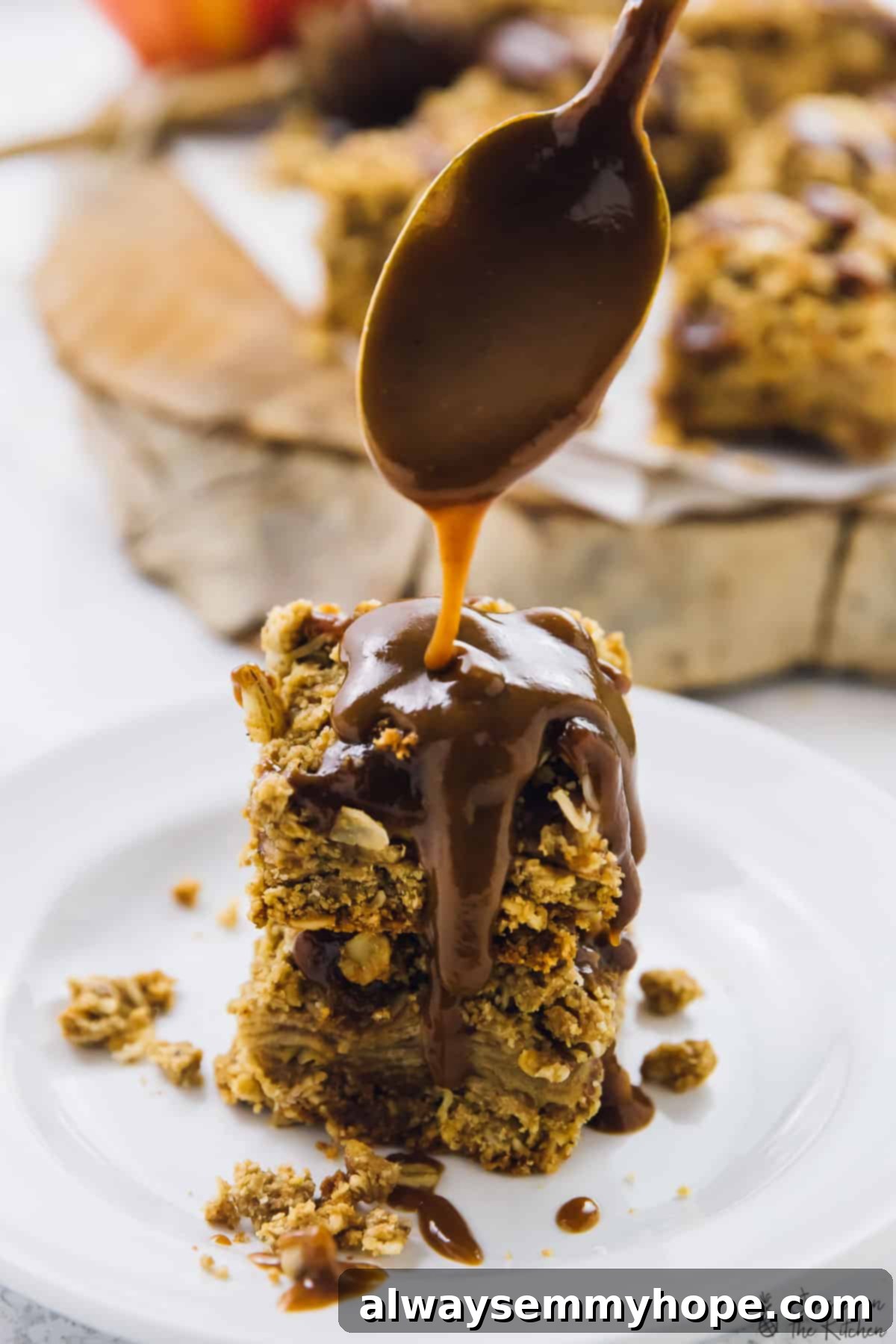 15 Delicious Vegan Autumn Desserts 3 A stack of vegan apple pie bars drizzled with caramel sauce.