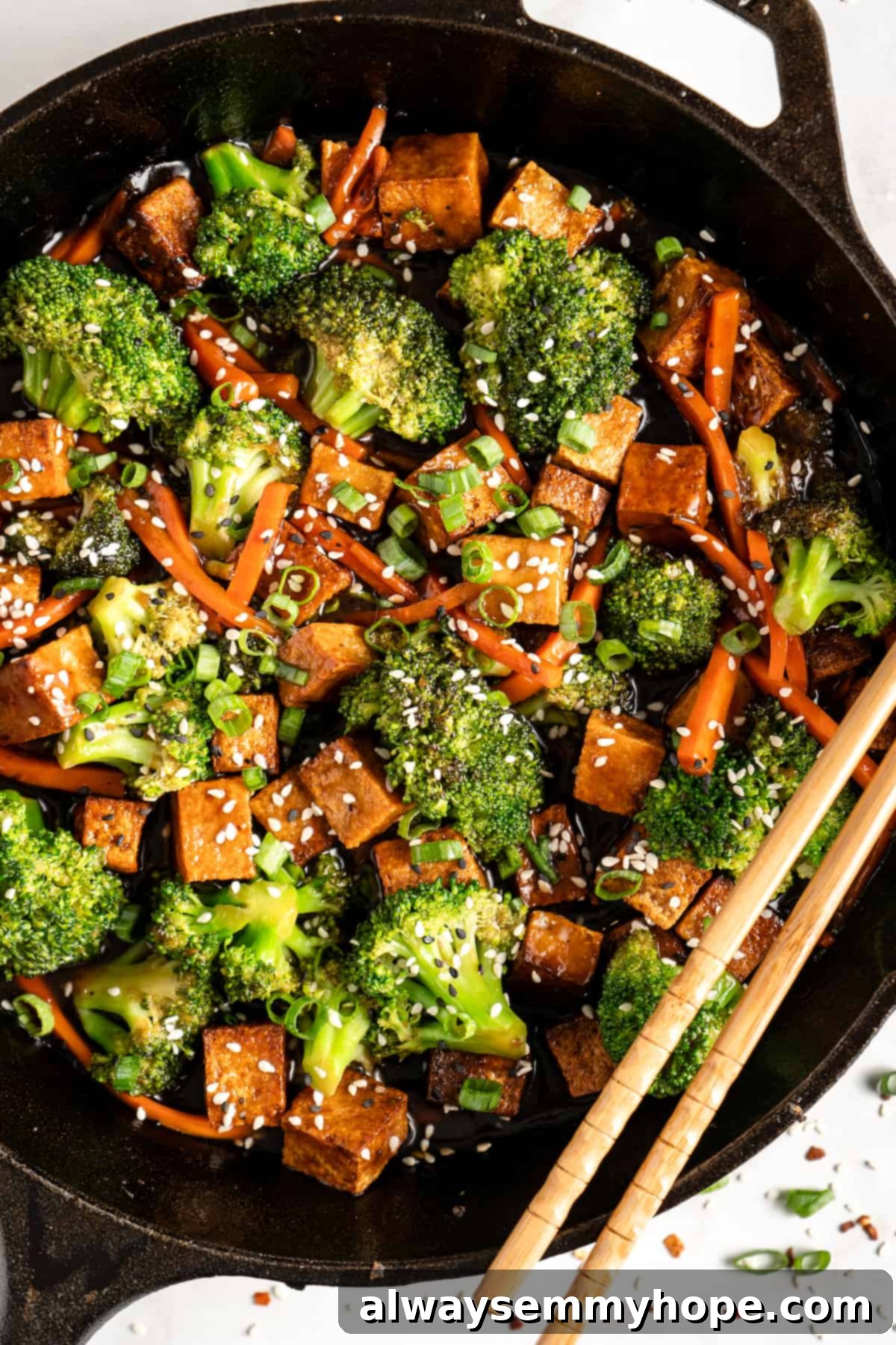 Glazed Ginger Tofu Stir-Fry 2 Veggie and tofu stir fry in cast iron skillet with chopsticks