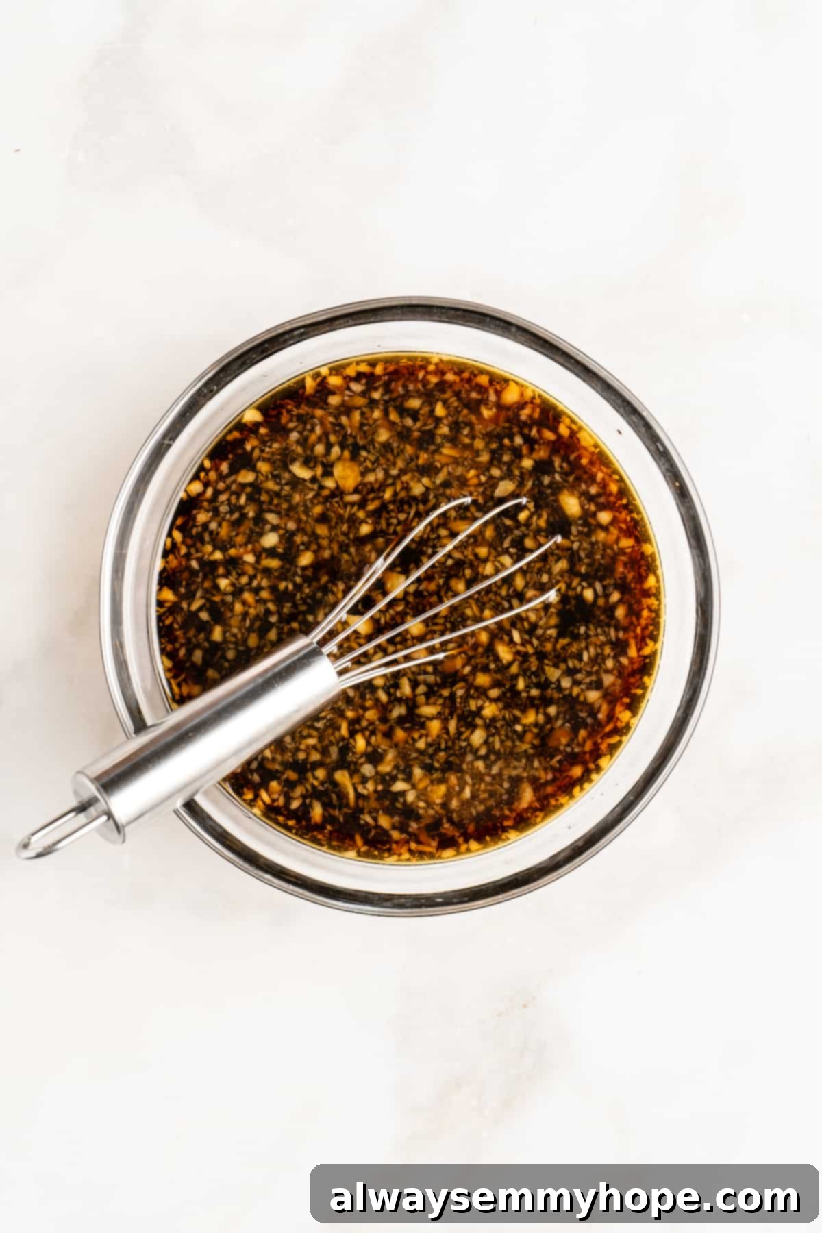 Glazed Ginger Tofu Stir-Fry 4 Overhead view of stir fry sauce in glass bowl with whisk