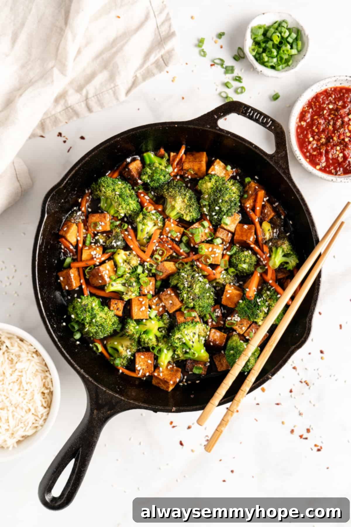 Glazed Ginger Tofu Stir-Fry 10 Overhead view of tofu and veggie stir fry in cast iron skillet with chopsticks