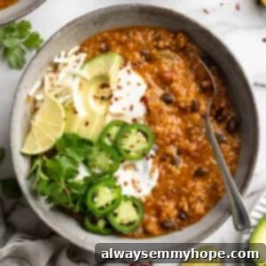 Close up of pumpkin chili topped with jalapenos and avocado