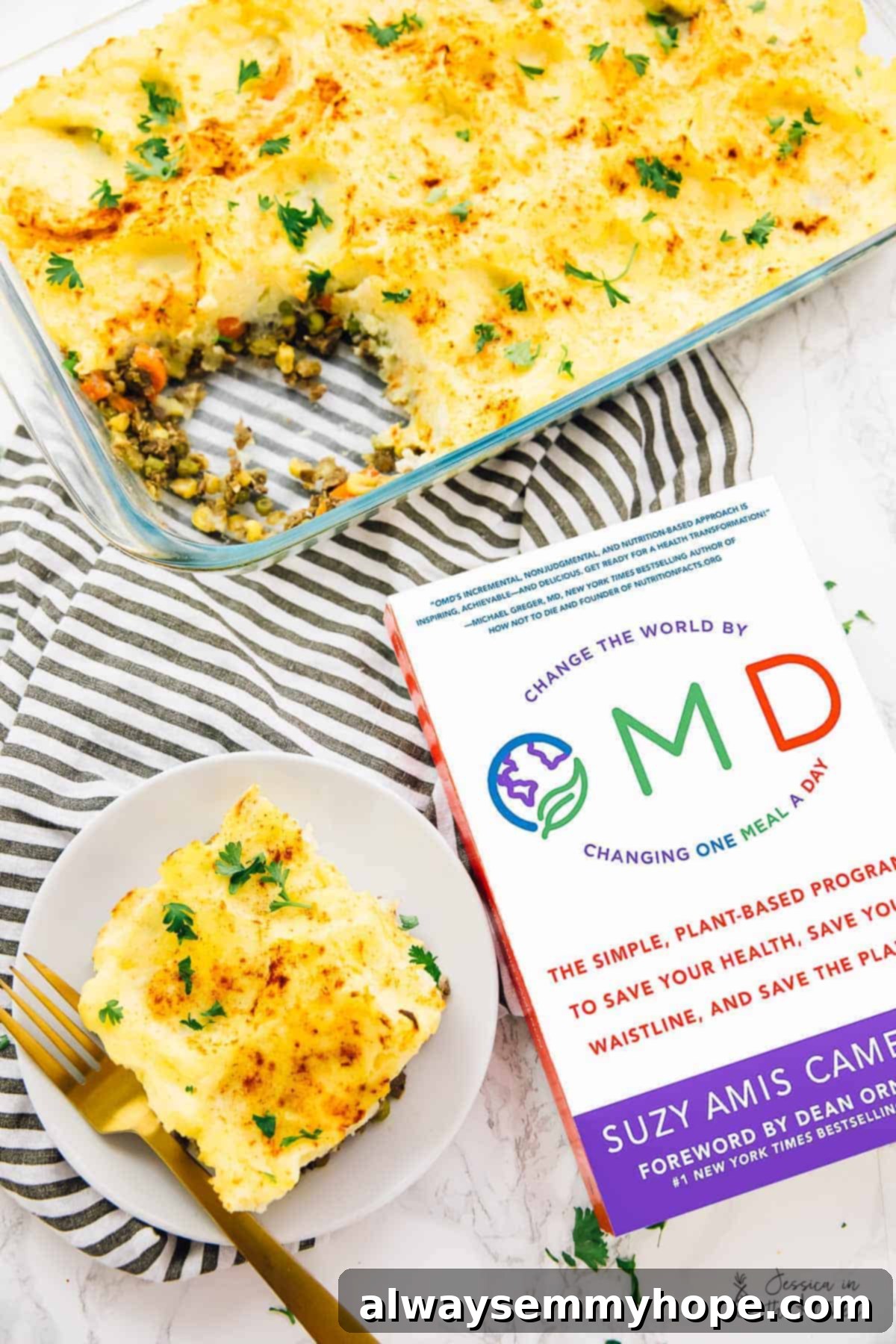 Regal Shepherd's Pie 5 An inviting scene featuring a full vegan shepherd's pie in a baking dish, a perfectly plated portion, and the inspiring OMD cookbook.