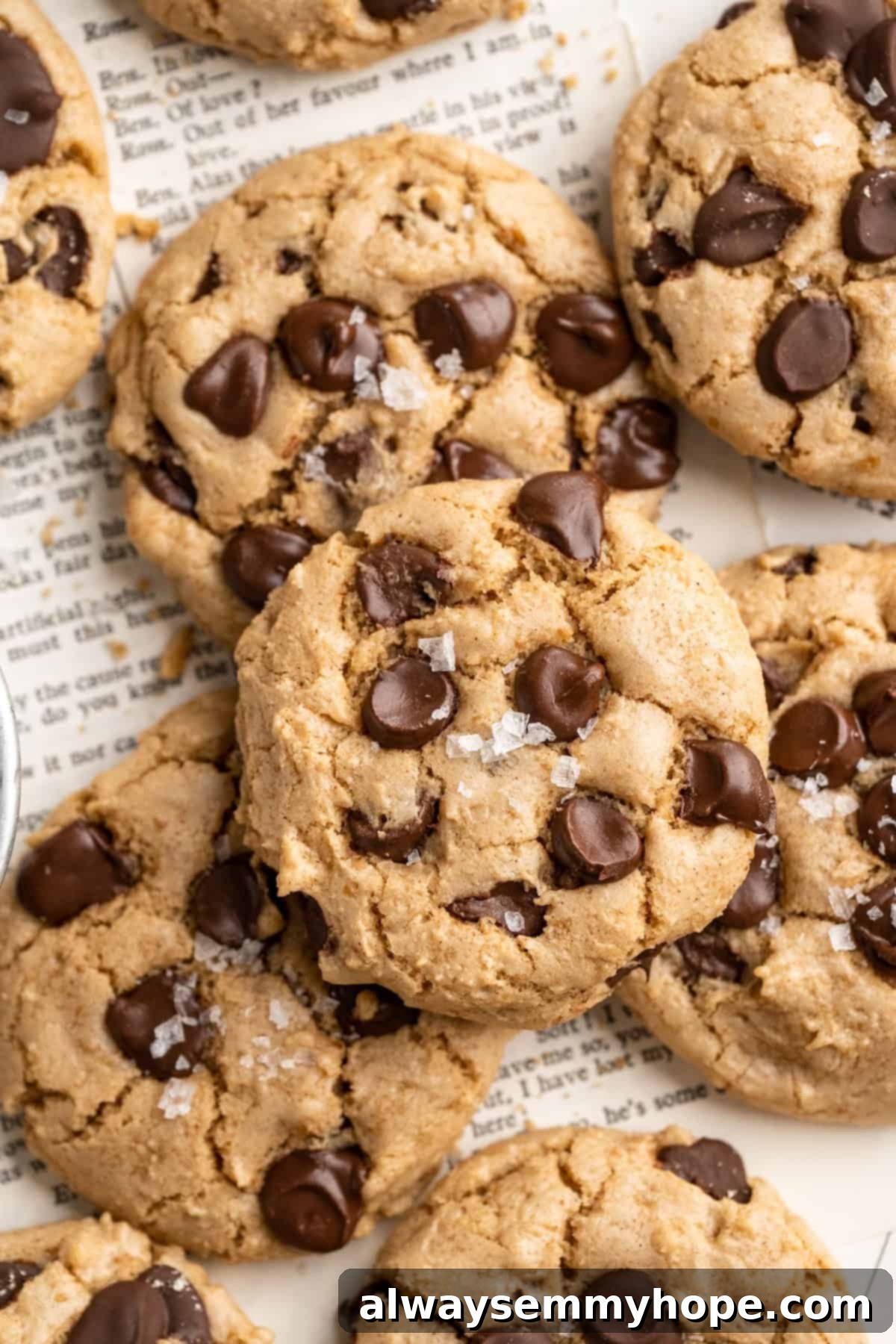 Discover the magic of these soft, chewy, and impossibly delicious Salted Chocolate Chip Tahini Cookies, a vegan and gluten-free delight! Close up of perfectly baked tahini chocolate chip cookies, showcasing their chewy texture and melted chocolate pools.
