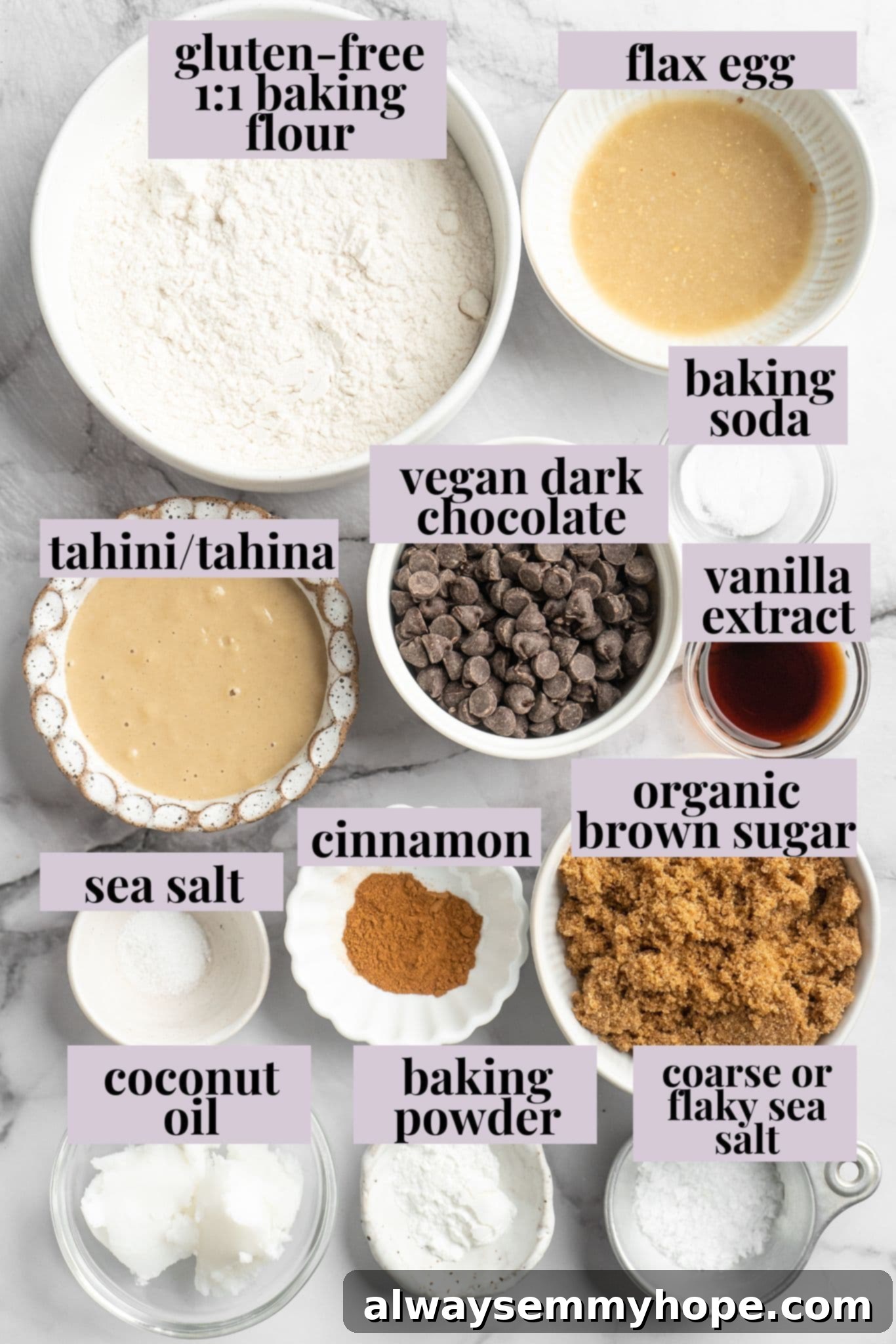 All the key ingredients you need to bake the perfect batch of Salted Chocolate Chip Tahini Cookies. Overhead view of fresh ingredients for making salted chocolate chip tahini cookies, including tahini, chocolate, and flour.