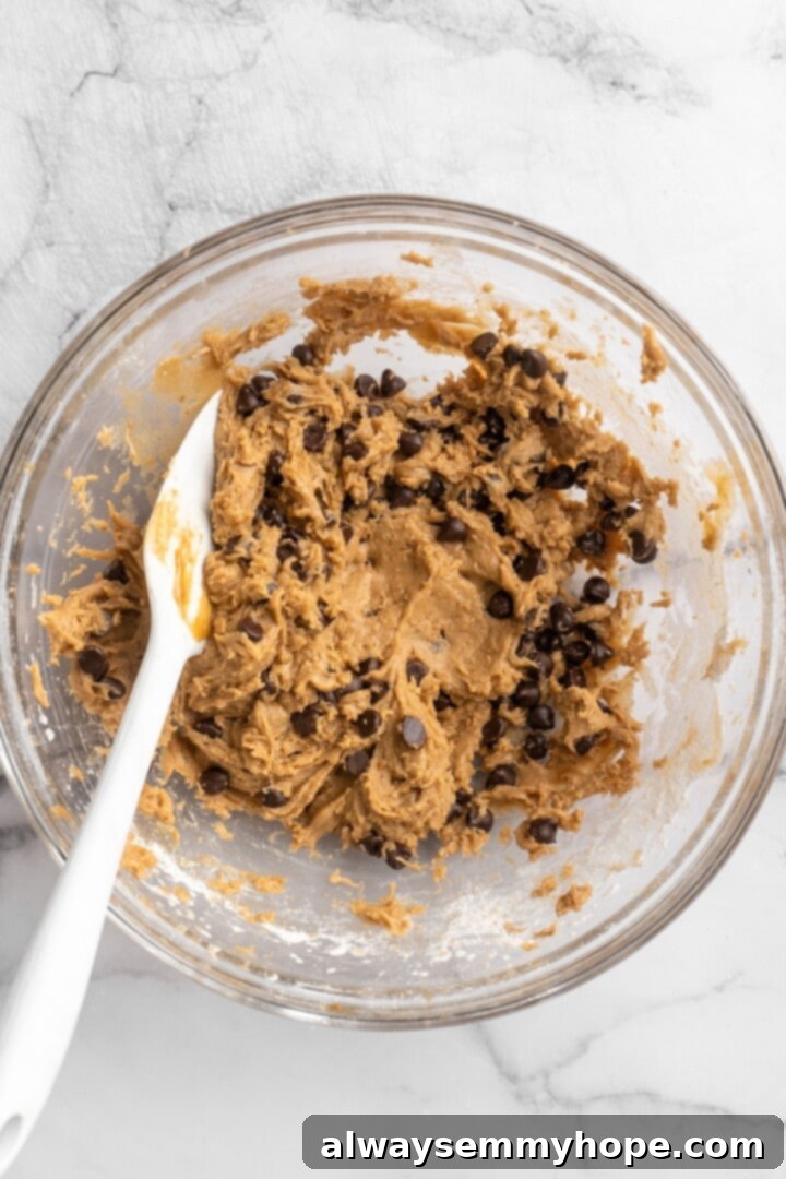 Decadent Chewy Salted Tahini Chocolate Chip Cookies 5 Folding vegan dark chocolate chunks into the finished tahini cookie dough.