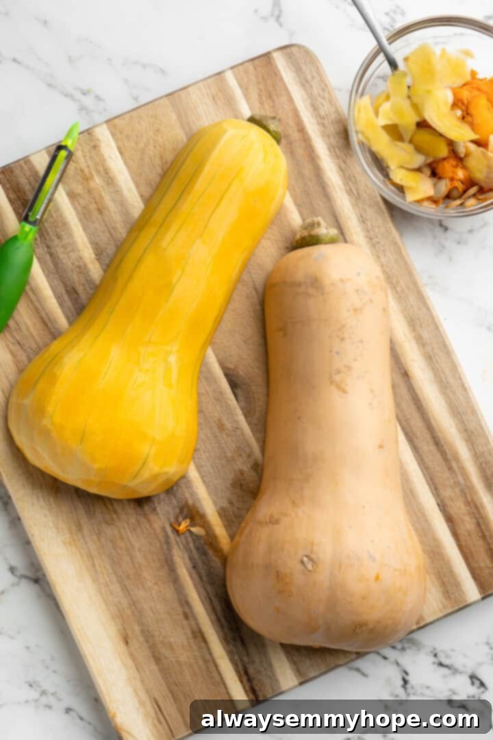 Hasselback butternut squash is a show-stopper, but it’s not all looks! Maple, tender squash, and caramelised pecans make it irresistible! Overhead view of two butternut squash halves on a cutting board, one completely peeled and the other still with its skin