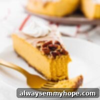 A slice of pumpkin cheesecake on a plate with a piece on a fork.