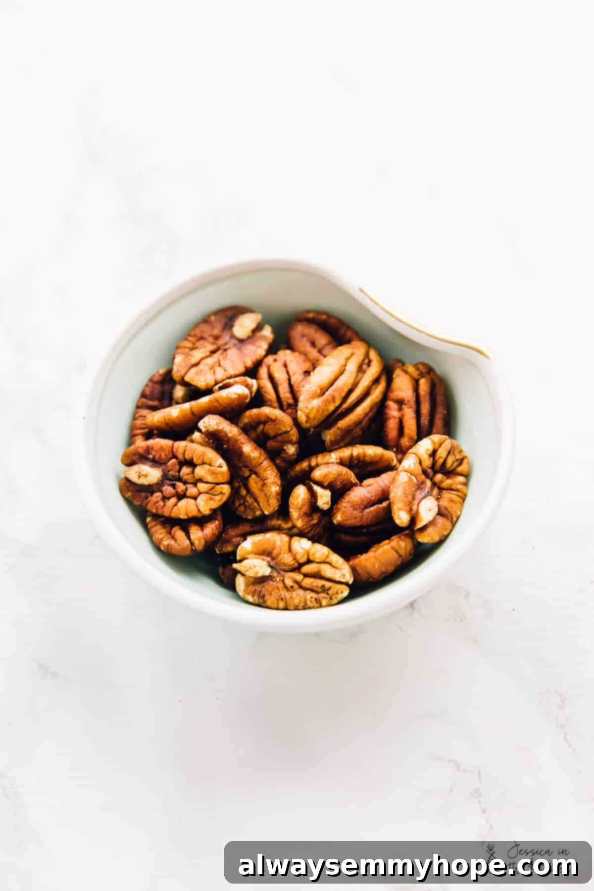 Overhead view pecans in a bowl.