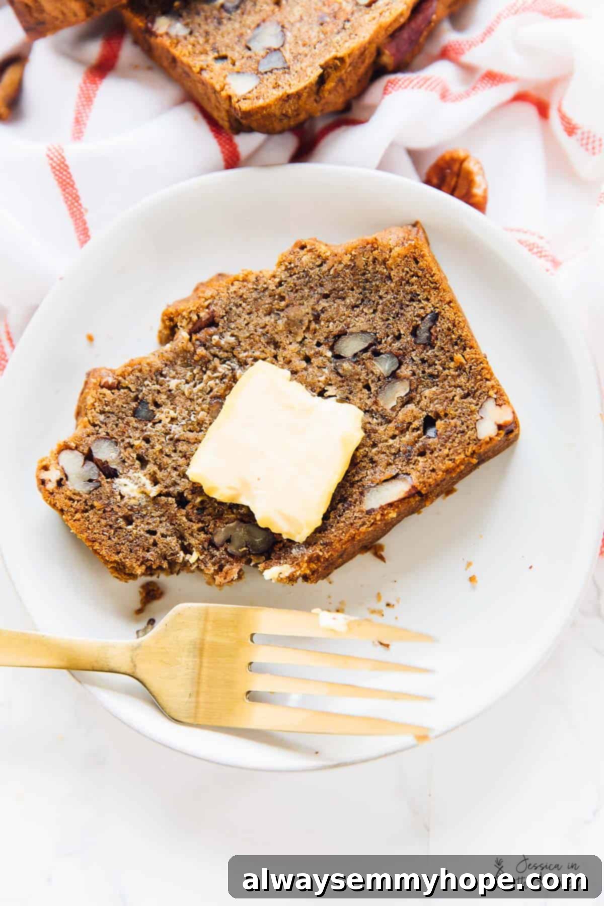 Delicious Vegan Gluten Free Pecan Banana Bread 6 A top-down view of a single slice of warm pecan banana bread, with a melting pat of vegan butter on top, ready to be enjoyed.