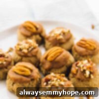 Golden Maple Pecan Sugar Cookies 7 Delightful maple pecan sugar cookies with frosting, presented beautifully on a white plate, ready to be enjoyed as a festive treat.