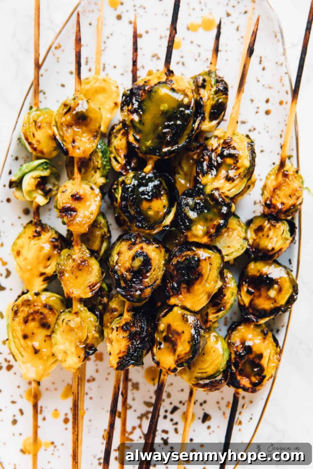Top down shot of grilled maple mustard brussels sprouts on skewers. 